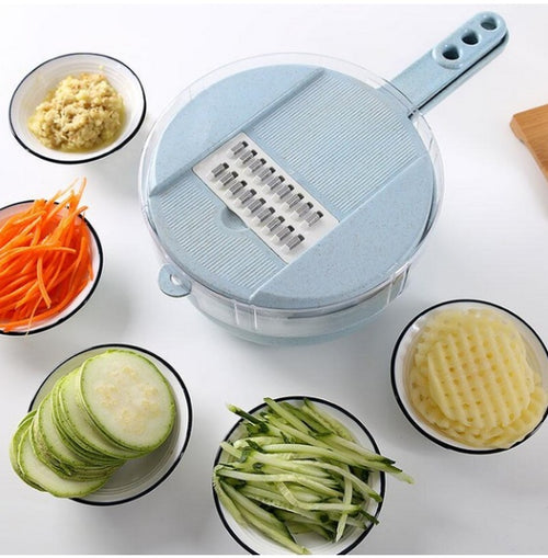 Blue slicer with bowls of sliced carrots, cucumber, zucchini & grated veg