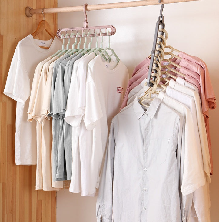Collection of shirts on hangers against a wooden wall.